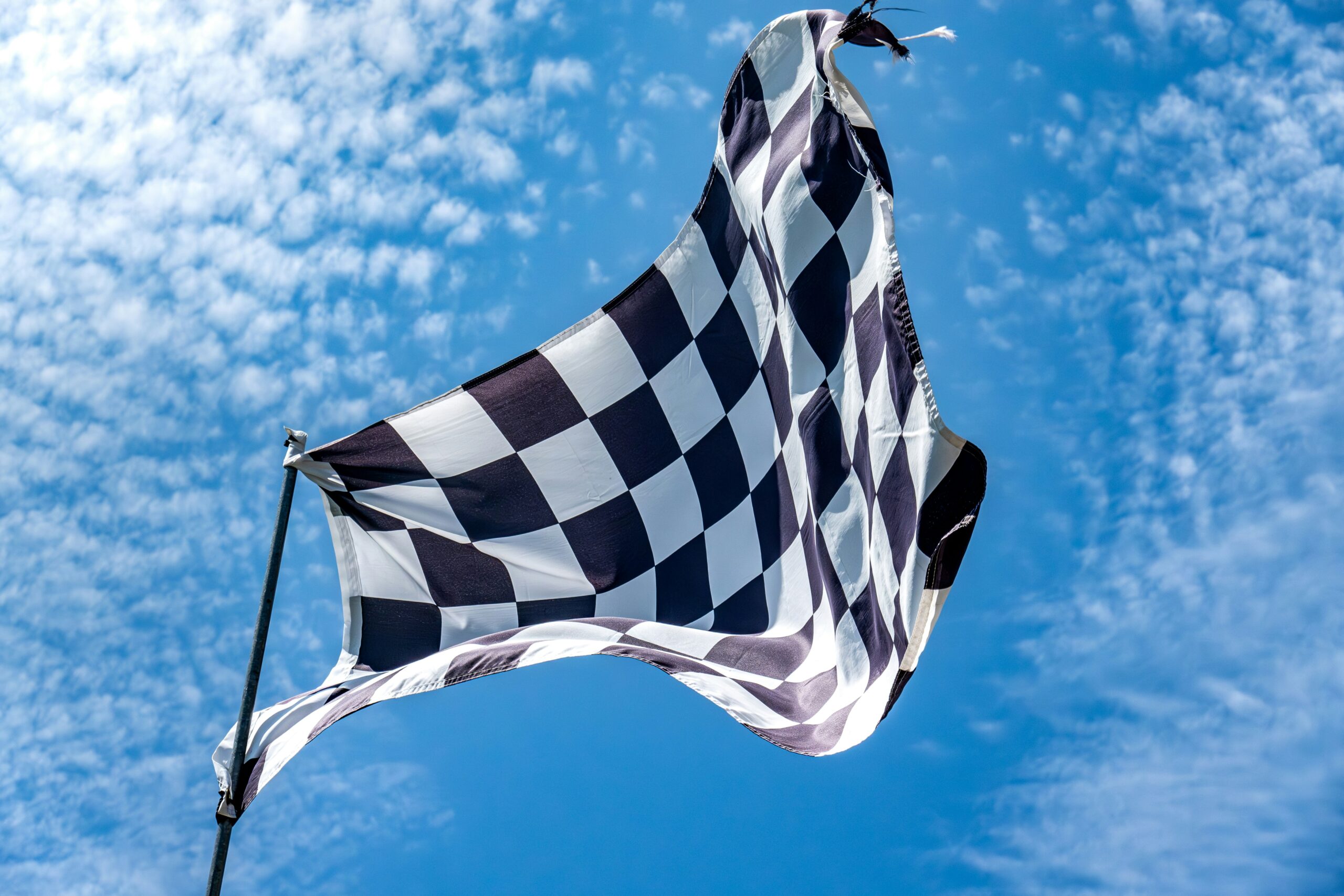 Why is waving the checkered flag such an exciting moment? Learn the history behind this symbol.